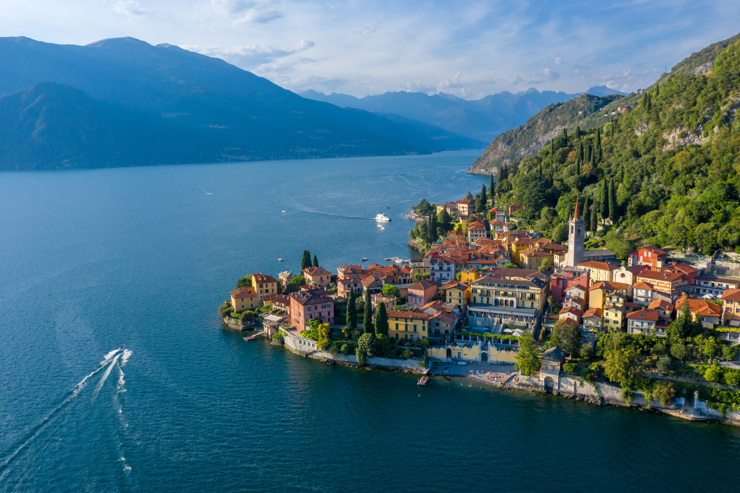 Village of Varenna on Como lake in Italy. Varenna by Lake Como in Italy, aerial view of the old town with the church of San Giorgio in the central square. Famous mountain lake in Italy